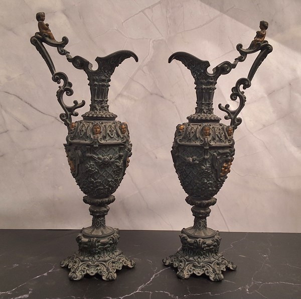 Lot 1340 - A PAIR OF SPELTER EWERS