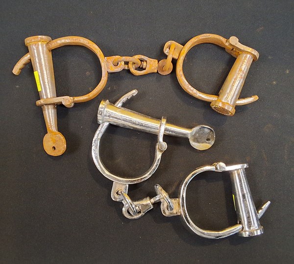 Lot 1201 - TWO PAIRS OF HANDCUFFS