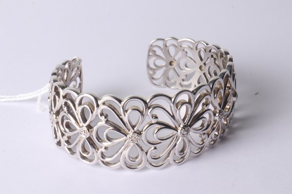 Lot 1040 - SILVER BANGLE with DIAMONDS