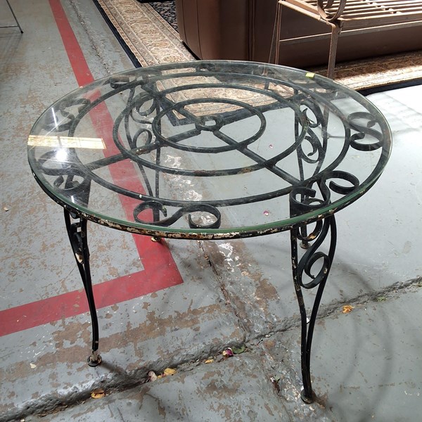 Lot 366 - Garden table ornate scroll iron with glass top,...